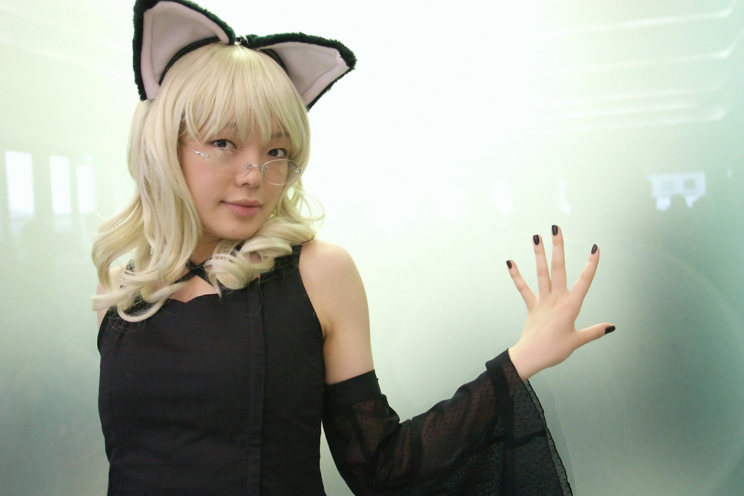 namada, elfriede, tsukuyomi moonphase, photo (medium), 1girl, animal ears, asian, bare shoulders, black dress, black nails, blonde hair, breasts, cat ears, cosplay, detached sleeves, dress, elfriede (cosplay), fake animal ears, female focus, glass wall, glasses, hand on wall, long hair, looking at viewer, looking over eyewear, mole, nail polish, reflection, rimless eyewear, see-through clothes, small breasts, solo, standing, upper body