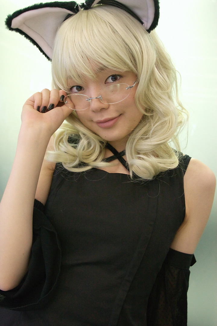 namada, elfriede, tsukuyomi moonphase, photo (medium), 1girl, adjusting eyewear, animal ears, asian, bare shoulders, black dress, black nails, blonde hair, breasts, cat ears, contrapposto, cosplay, detached sleeves, dress, elfriede (cosplay), fake animal ears, female focus, glass wall, glasses, hand on eyewear, long hair, looking at viewer, looking over eyewear, mole, nail polish, reflection, rimless eyewear, small breasts, solo, standing, upper body