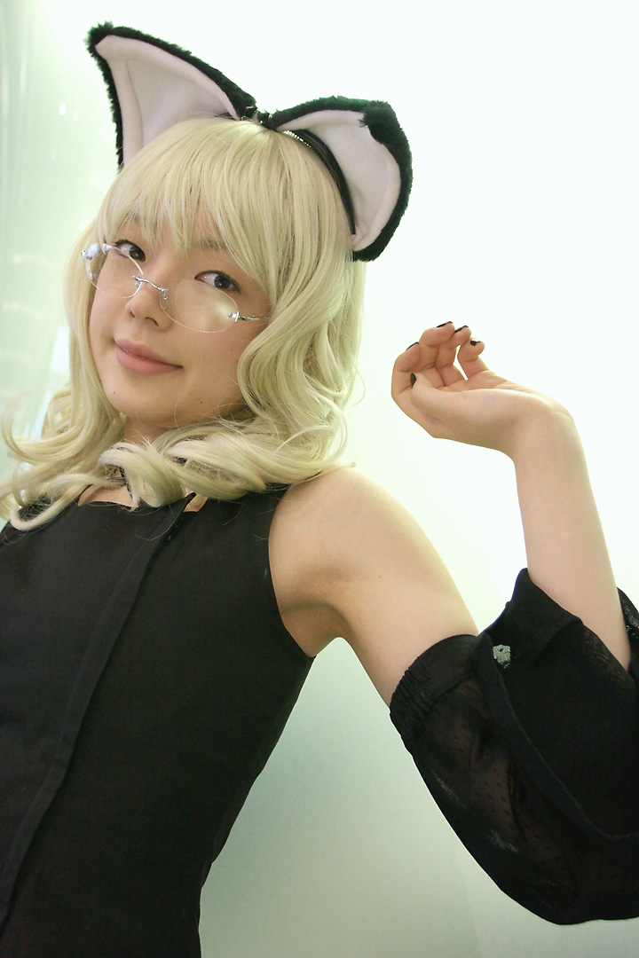 namada, elfriede, tsukuyomi moonphase, photo (medium), 1girl, animal ears, armpits, asian, bare shoulders, black dress, black nails, blonde hair, breasts, cat ears, cosplay, detached sleeves, dress, elfriede (cosplay), fake animal ears, female focus, glass wall, glasses, long hair, looking at viewer, looking over eyewear, mole, nail polish, reflection, rimless eyewear, small breasts, solo, standing, upper body