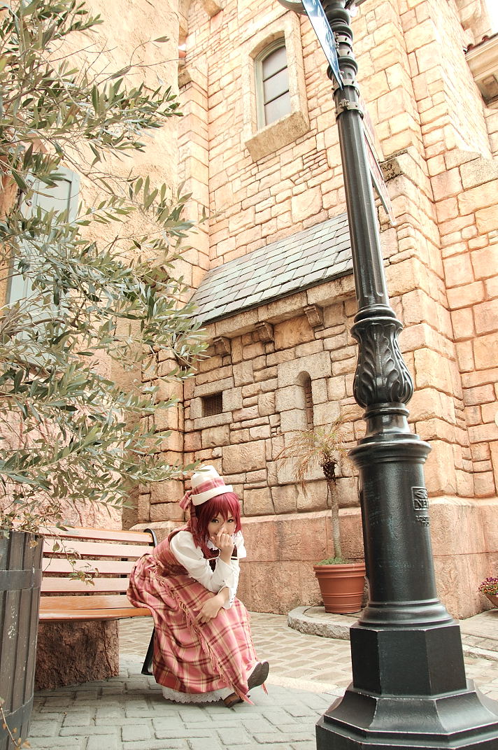 kipi-san, esther blanchett, trinity blood, cosplay photo, photo (medium), 1girl, asian, bench, cosplay, dress, esther blanchett (cosplay), female focus, hat, lamppost, looking at viewer, outdoors, park bench, plaid clothes, plaid skirt, puffy sleeves, red hair, road, sitting, skirt, solo, street