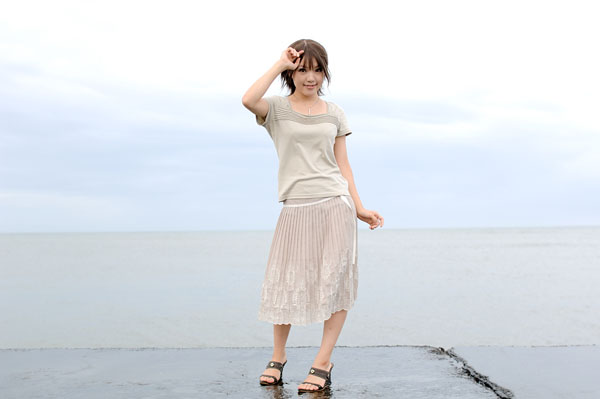 kipi-san, photo (medium), 1girl, asian, beach, brown hair, dress, female focus, looking at viewer, ocean, outdoors, sand, skirt, solo, wet