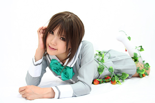 kipi-san, sotomura misuzu, ichigo 100%, photo (medium), 1girl, asian, brown eyes, brown hair, cosplay, female focus, food, fruit, kneehighs, looking at viewer, lying, on floor, on stomach, school uniform, simple background, socks, solo, sotomura misuzu (cosplay), strawberry, white background, white socks