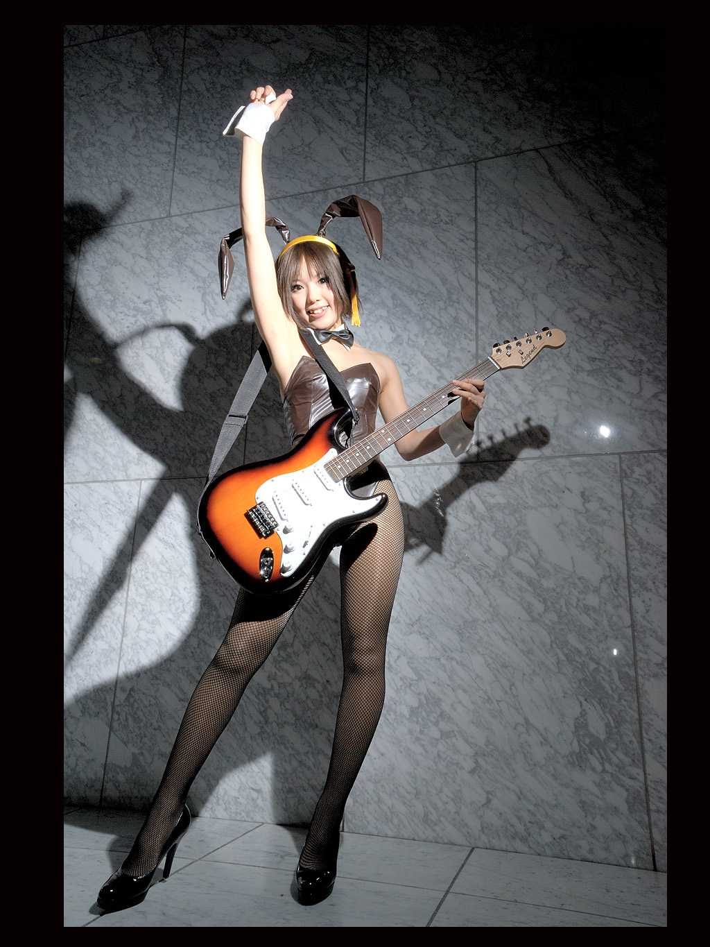 kipi-san, suzumiya haruhi, suzumiya haruhi no yuuutsu, highres, photo (medium), 1girl, animal ears, asian, brown eyes, brown hair, cosplay, dutch angle, fake animal ears, female focus, fishnet pantyhose, fishnets, guitar, hair ribbon, hairband, indoors, instrument, leotard, looking at viewer, pantyhose, playboy bunny, rabbit ears, ribbon, solo, suzumiya haruhi (cosplay)