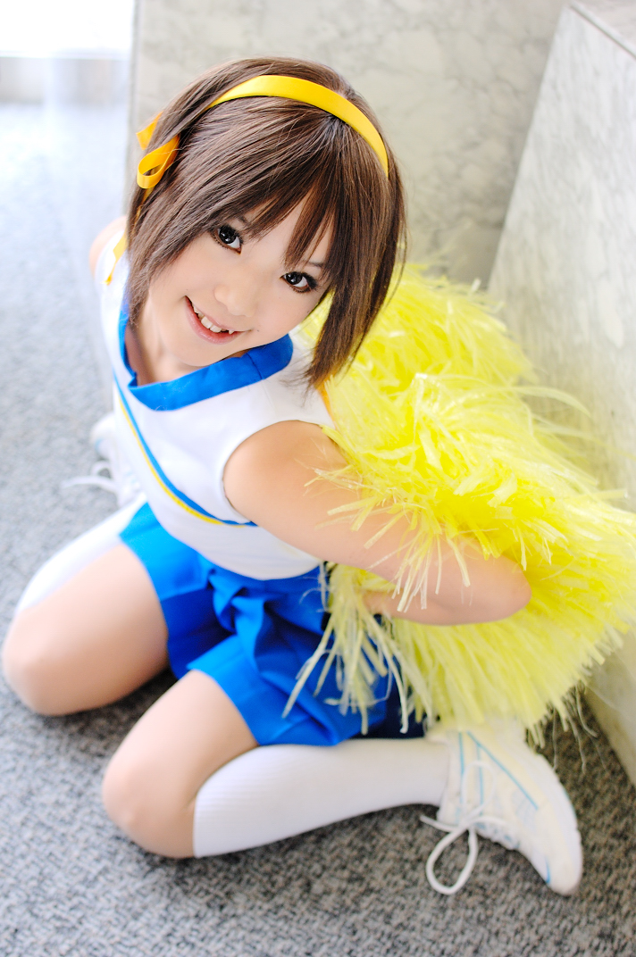 kipi-san, suzumiya haruhi, suzumiya haruhi no yuuutsu, photo (medium), 1girl, asian, brown eyes, brown hair, cheerleader, cosplay, female focus, hair ribbon, looking at viewer, mole, pom pom (cheerleading), ribbon, sitting, smile, socks, solo, suzumiya haruhi (cosplay), wariza