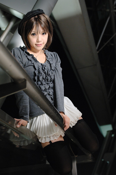 kipi-san, photo (medium), 1girl, asian, bag, beret, black thighhighs, boots, female focus, garter straps, hat, looking at viewer, miniskirt, pleated skirt, short hair, skirt, solo, straddling, sweater, thighhighs