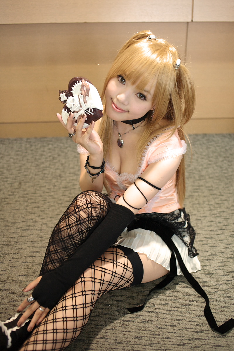 kipi-san, amane misa, death note, highres, photo (medium), 1girl, amane misa (cosplay), asian, bare shoulders, blonde hair, breasts, choker, cosplay, cross, elbow gloves, female focus, fingerless gloves, fishnet thighhighs, fishnets, gloves, hair ornament, indoors, jewelry, lace, long hair, looking at viewer, miniskirt, mole, pendant, ring, single glove, skirt, skull and crossbones, skull hair ornament, skull ring, small breasts, smile, solo, thighhighs, two side up
