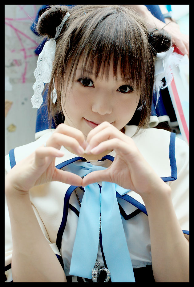 kipi-san, acasius boarding school, photo (medium), 1girl, asian, brown hair, cosplay, double bun, female focus, hair bun, heart, heart hands, looking at viewer, mole, school uniform, short hair, solo