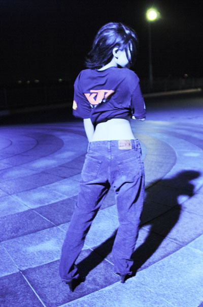 kipi-san, photo (medium), tagme, 1girl, asian, dutch angle, female focus, from behind, midriff, night, outdoors, pants, shirt, solo, t-shirt