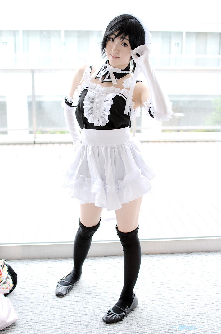 minami riko, sawatari izumi, kore ga watashi no goshujin-sama, photo (medium), 1girl, apron, asian, bare shoulders, black hair, black shoes, black thighhighs, carpet, cosplay, detached collar, elbow gloves, facing viewer, female focus, full body, gloves, indoors, japanese (nationality), looking at viewer, maid, maid apron, maid headdress, nakabayashi yoshitaka's maid uniform, sawatari izumi (cosplay), shoes, short hair, solo, standing, thighhighs, waist apron, white apron, white gloves, window