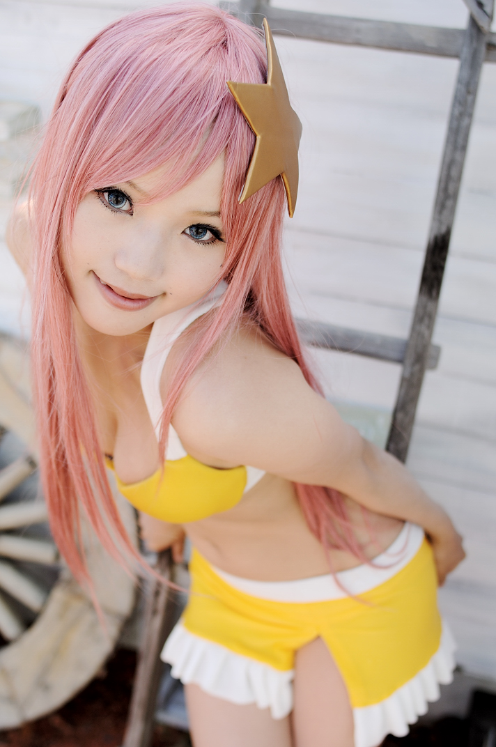 kipi-san, meer campbell, gundam, gundam seed, photo (medium), 1girl, asian, bikini, blue eyes, breasts, cleavage, color contacts, cosplay, dutch angle, female focus, leaning forward, long hair, looking at viewer, meer campbell (cosplay), mole, outdoors, pink hair, solo, swimsuit, yellow bikini