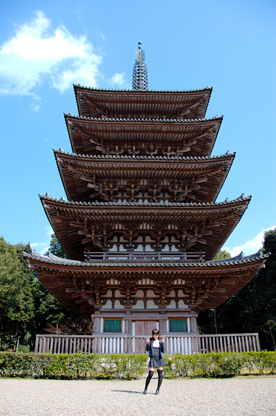 kipi-san, photo (medium), tagme, 1girl, asian, black thighhighs, cloud, contrapposto, double v, dress, female focus, jacket, loafers, looking at viewer, outdoors, pagoda, pinafore dress, railing, shoes, sky, sleeveless, sleeveless dress, solo, thighhighs, tree, v, zettai ryouiki