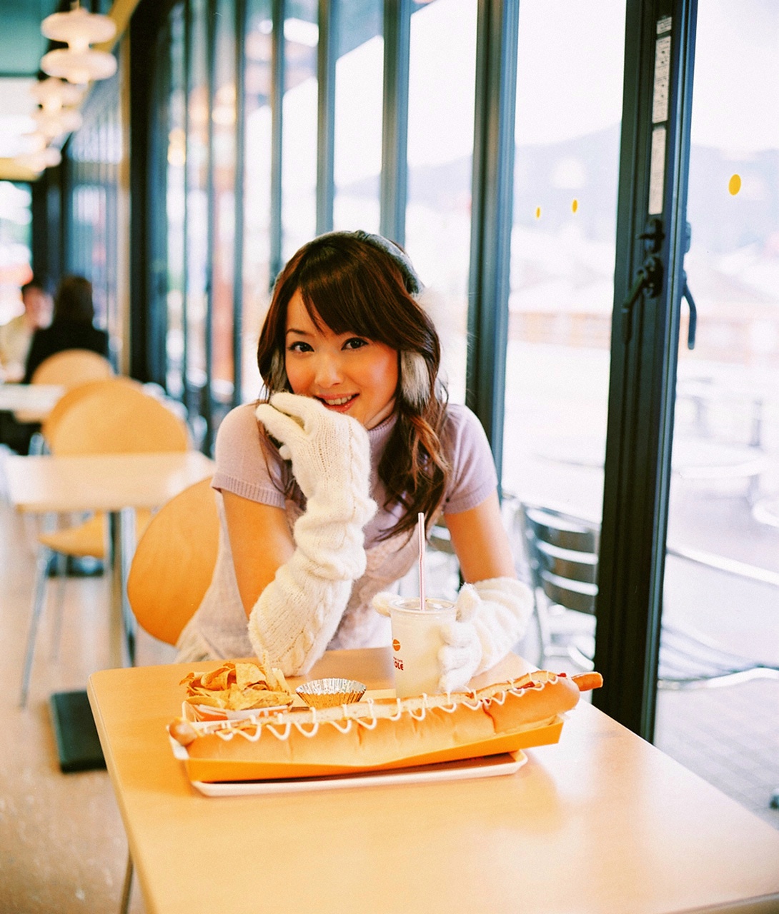 nozomi sasaki, highres, photo (medium), earmuffs, giant hotdog, gloves, sweater