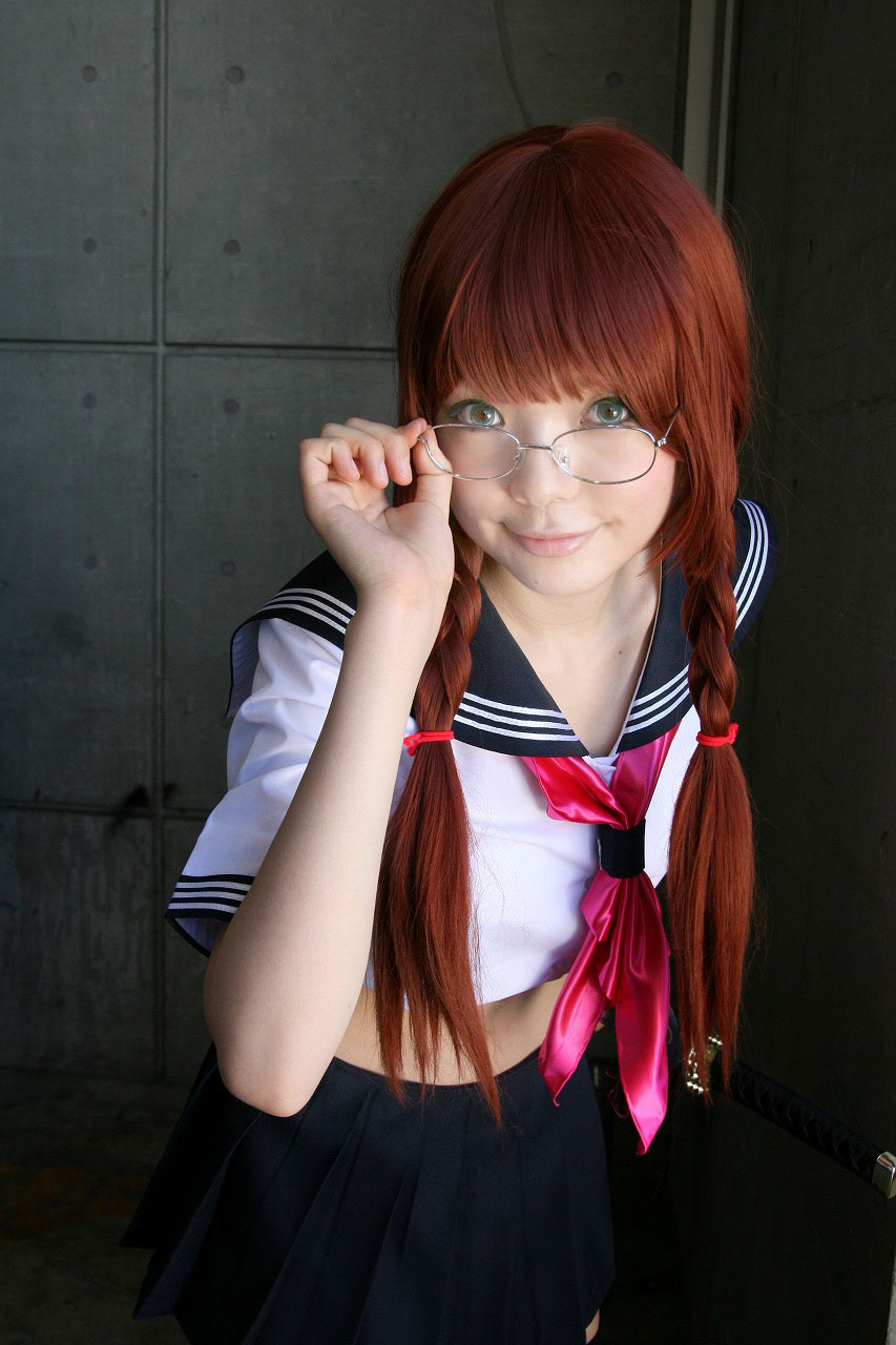 namada, arisugawa shii, the art of yamashita shunya, highres, photo (medium), 1girl, aqua eyes, arisugawa shii (cosplay), asian, blue eyes, blurry, braid, brown hair, color contacts, cosplay, crop top, depth of field, female focus, glasses, green eyes, indoors, lensless glasses, long hair, looking at viewer, looking over eyewear, midriff, miniskirt, pleated skirt, sailor, school uniform, serafuku, short sleeves, skirt, solo, standing, sword, twin braids, weapon
