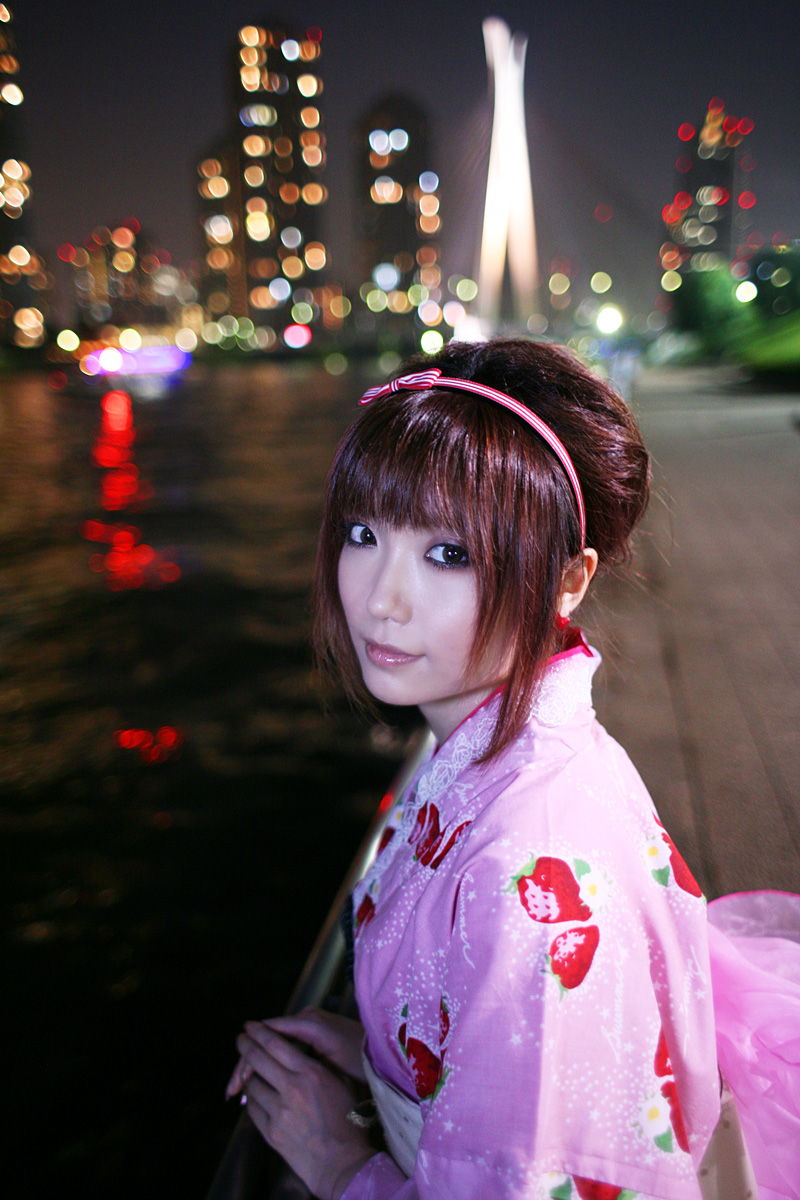 shio, highres, photo (medium), 1girl, cityscape, female focus, hairband, japanese clothes, kimono, night, solo, strawberry pattern, water, waterfront