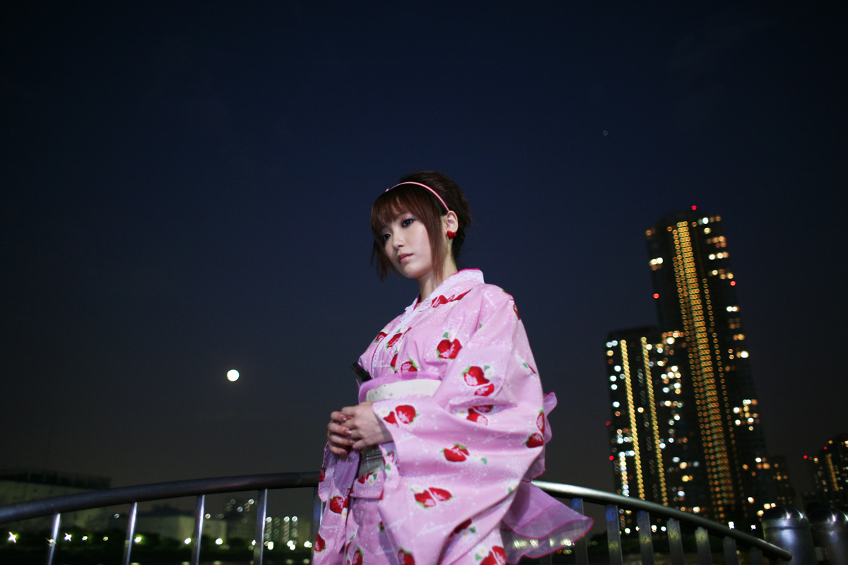 shio, photo (medium), 1girl, cityscape, female focus, hairband, japanese clothes, kimono, night, solo, strawberry pattern, waterfront