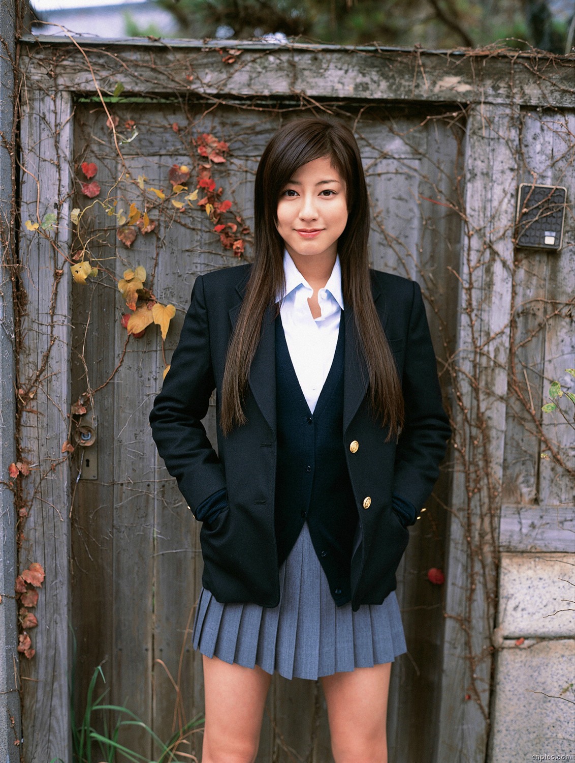 sugimoto yumi, highres, photo (medium), 1girl, asian, blazer, brown hair, cardigan, cosplay, female focus, jacket, legs apart, long hair, looking at viewer, miniskirt, pleated skirt, school uniform, skirt, solo, standing