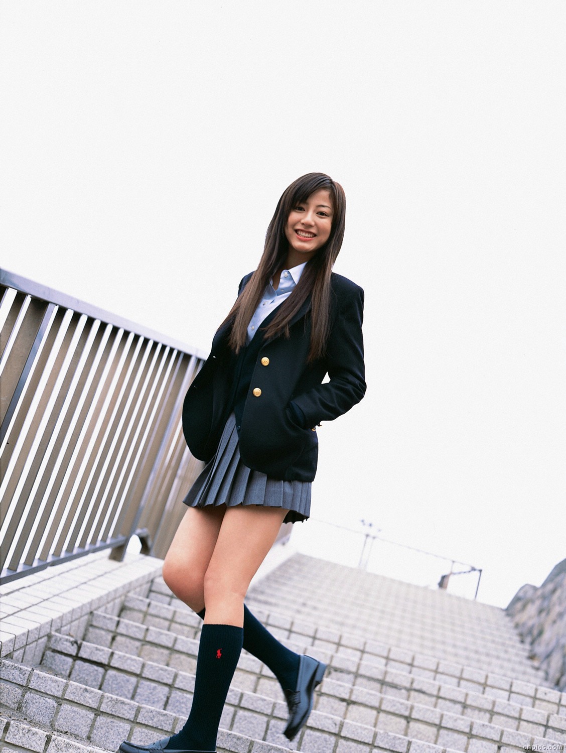 sugimoto yumi, highres, photo (medium), 1girl, asian, blazer, brown hair, cardigan, cosplay, dutch angle, female focus, jacket, kneehighs, long hair, looking at viewer, miniskirt, outdoors, pleated skirt, school uniform, skirt, socks, solo