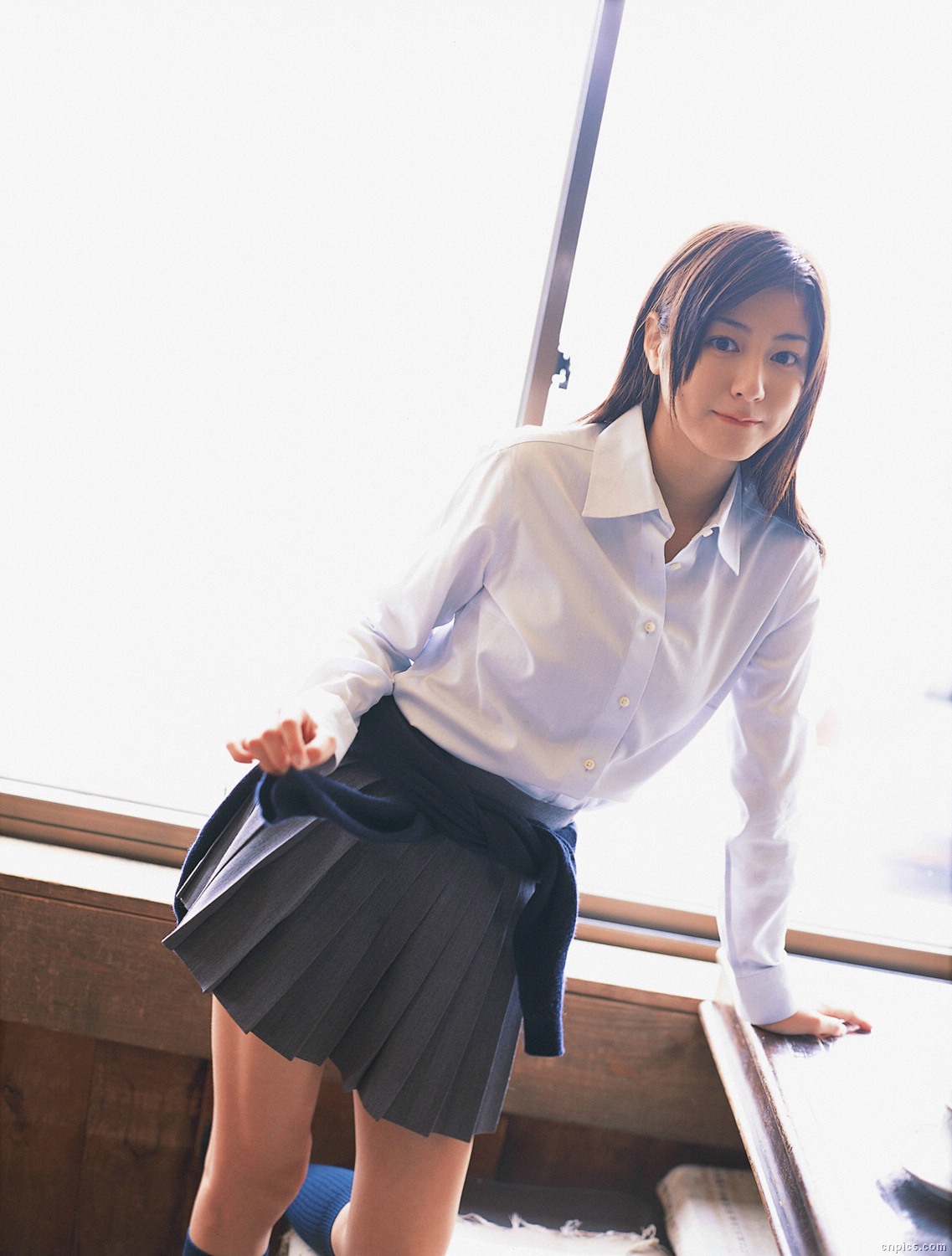 sugimoto yumi, highres, photo (medium), 1girl, asian, brown hair, cardigan, cosplay, dutch angle, female focus, indoors, kneehighs, long hair, looking at viewer, miniskirt, pleated skirt, school uniform, skirt, socks, solo