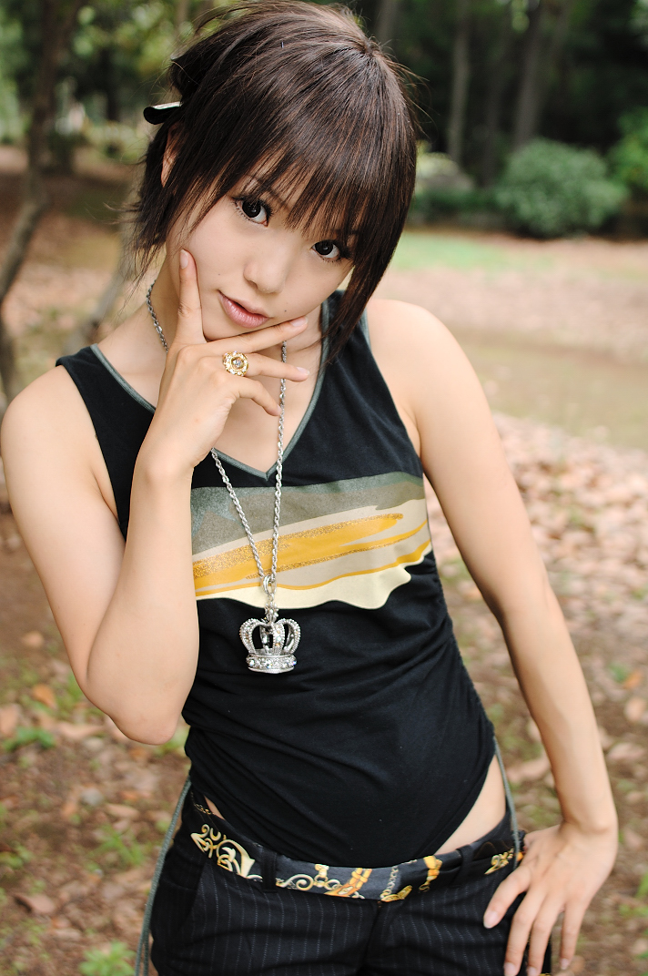 kipi-san, photo (medium), tagme, 1girl, asian, bling, blurry, breasts, brown eyes, brown hair, contrapposto, depth of field, female focus, hand on own hip, jewelry, looking at viewer, mole, outdoors, pendant, ring, short hair, small breasts, solo, tank top, tree