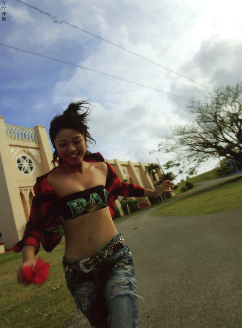 hasebe yu, real life, photo (medium), 1girl, asian, belt, blurry, breasts, building, cloud, denim, depth of field, dutch angle, female focus, flower, jeans, long hair, open clothes, open shirt, outdoors, pants, plaid clothes, plaid shirt, running, shirt, sky, small breasts, solo, strapless, torn clothes, tree, tube top