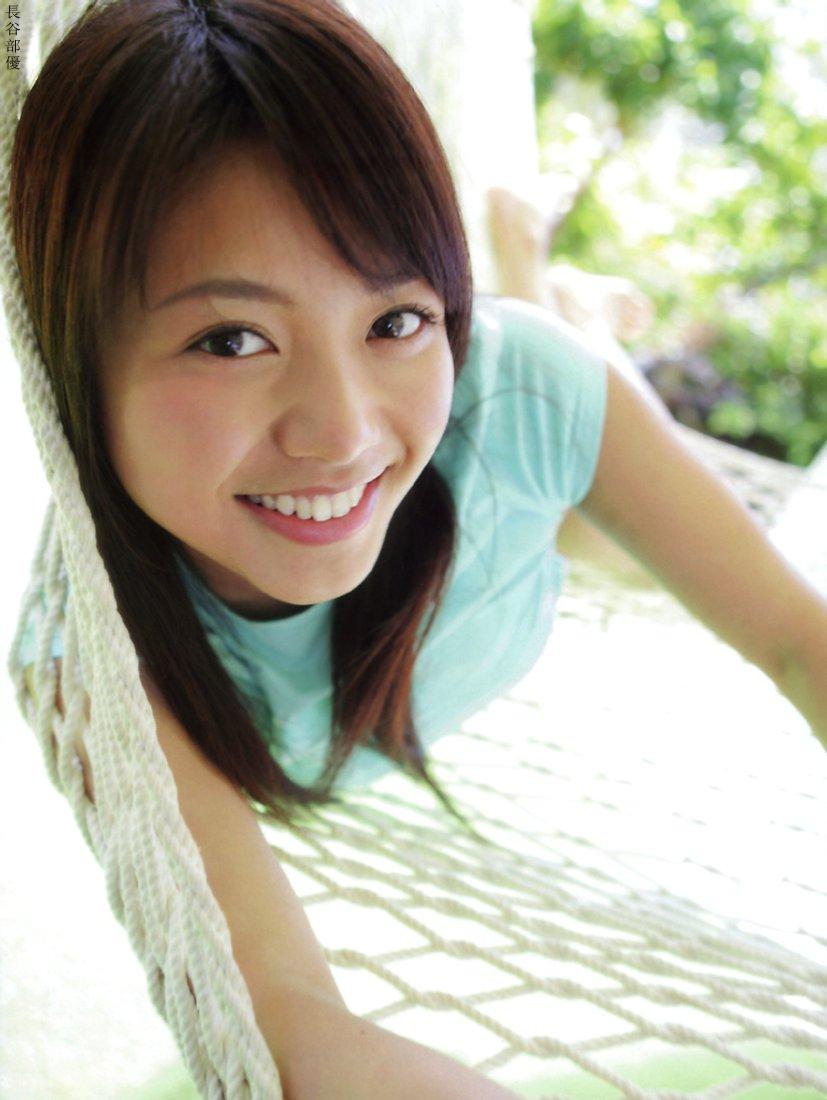 hasebe yu, photo (medium), tagme, 1girl, asian, blurry, breasts, brown hair, depth of field, female focus, hammock, looking at viewer, shirt, small breasts, smile, solo, t-shirt