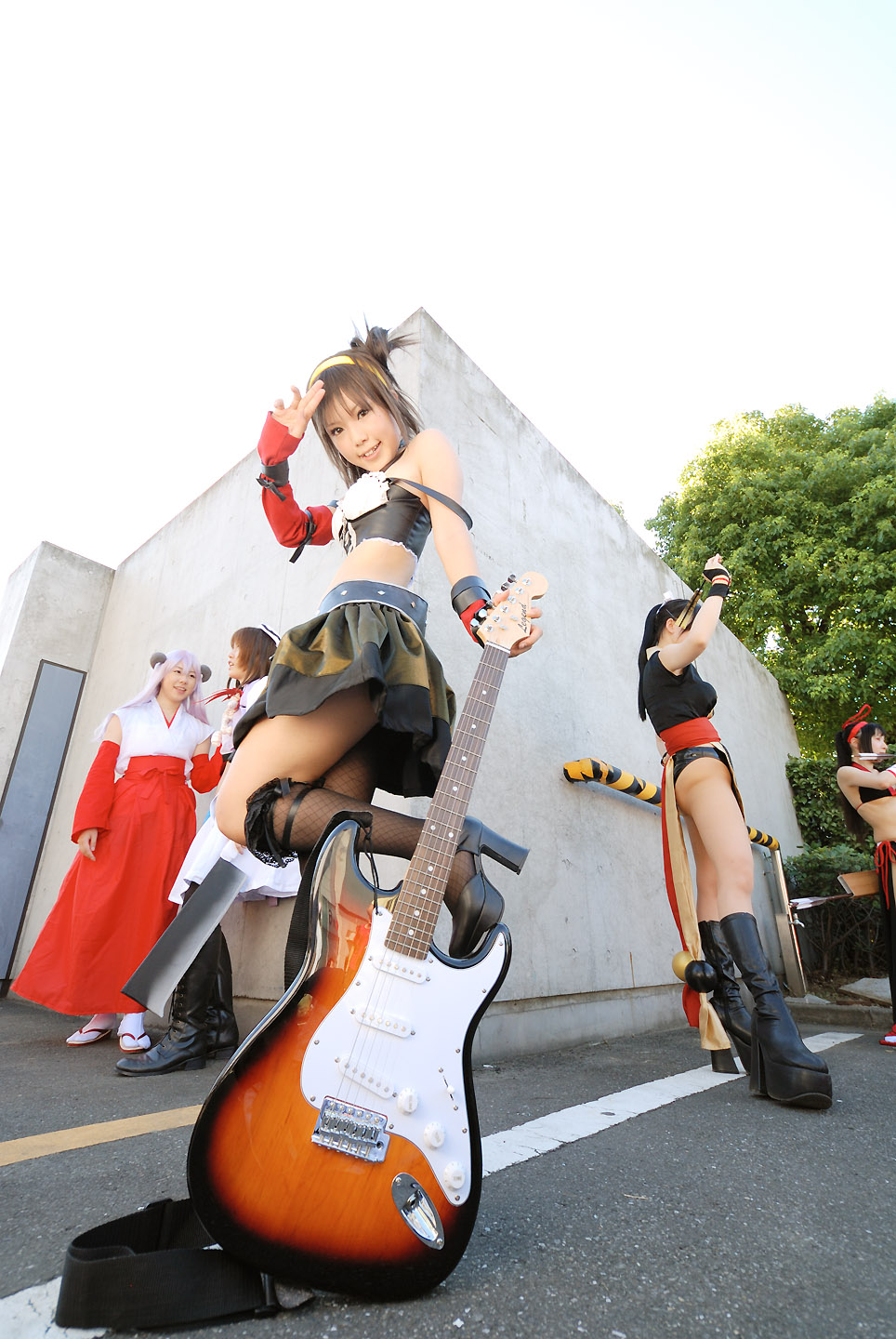 kipi-san, suzumiya haruhi, suzumiya haruhi no yuuutsu, fishnet legwear, highres, photo (medium), 5girls, asian, belt, breasts, cosplay, elbow gloves, fishnets, gloves, guitar, hairband, instrument, looking at viewer, midriff, multiple girls, single thighhigh, small breasts, solo focus, suzumiya haruhi (cosplay), thighhighs