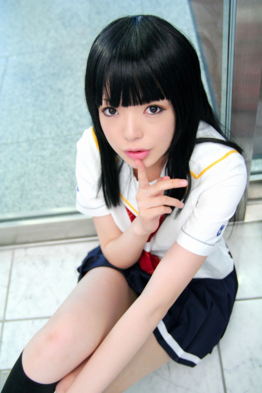 namada, futami eriko, kimi kiss, highres, photo (medium), 1girl, asian, black hair, blunt bangs, blurry, breasts, cosplay, depth of field, eyeliner, female focus, finger to mouth, from above, futami eriko (cosplay), indoors, kneehighs, long hair, looking at viewer, makeup, miniskirt, on floor, pleated skirt, school uniform, serafuku, shushing, sitting, skirt, small breasts, socks, solo