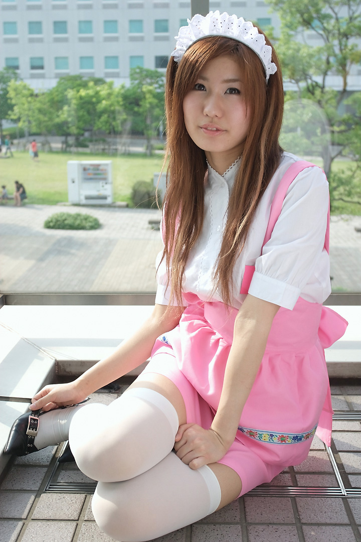 adachi mikki, anna miller, photo (medium), 1girl, apron, asian, blurry, brown hair, cosplay, depth of field, dyed hair, female focus, looking at viewer, on floor, outdoors, sitting, solo, thighhighs, tree, waitress, waitress uniform, white thighhighs, yokozuwari, zettai ryouiki