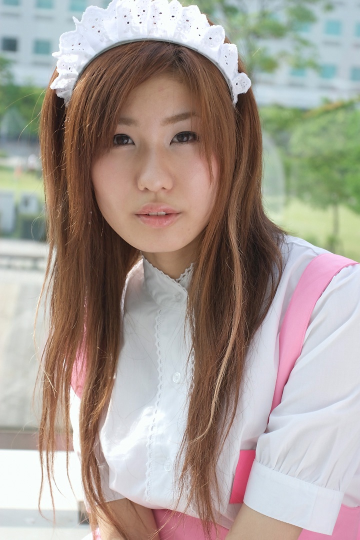 adachi mikki, anna miller, white legwear, photo (medium), 1girl, apron, asian, blurry, brown hair, cosplay, depth of field, dyed hair, female focus, looking at viewer, outdoors, parted lips, solo, tree, waitress, waitress uniform