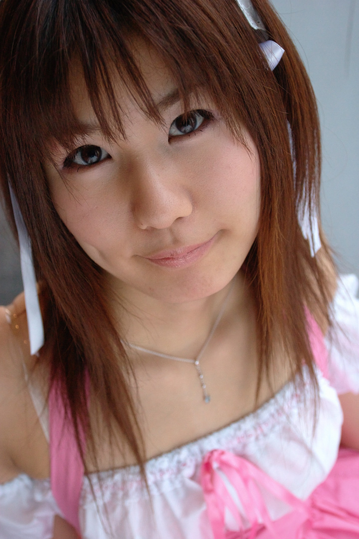 adachi mikki, photo (medium), 1girl, asian, brown hair, dress, dyed hair, female focus, hair ribbon, hairband, jewelry, looking at viewer, necklace, ribbon, solo, waitress uniform