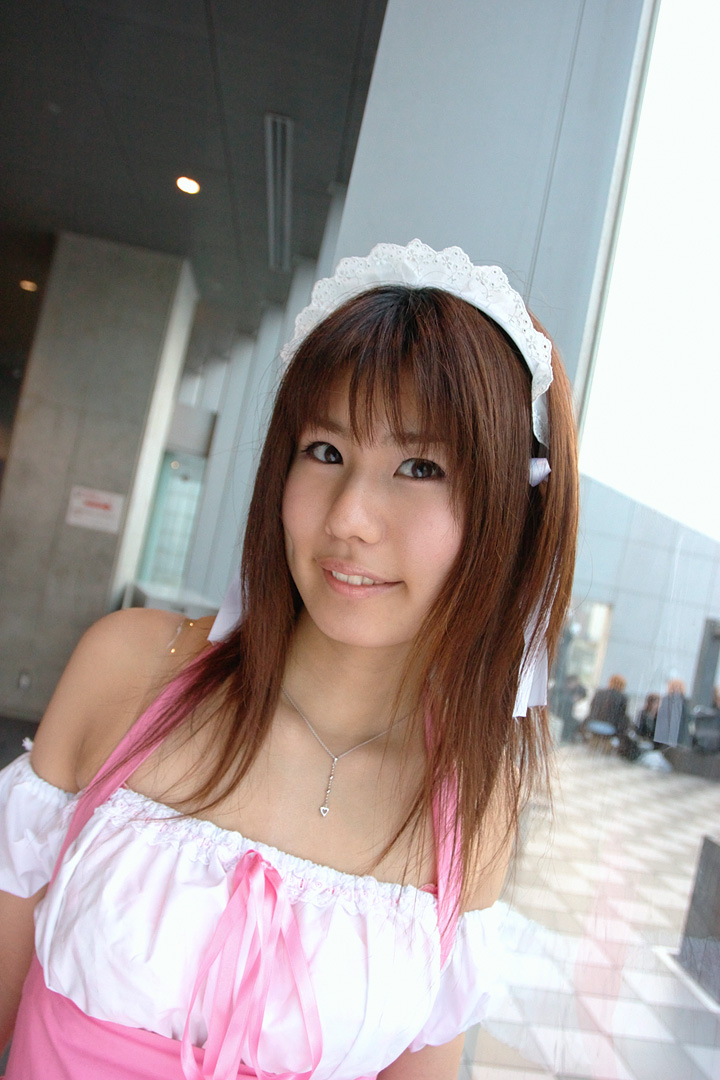 adachi mikki, photo (medium), 1girl, asian, bare shoulders, brown hair, dress, dutch angle, dyed hair, female focus, hair ribbon, hairband, indoors, jewelry, looking at viewer, necklace, ribbon, smile, solo, waitress uniform