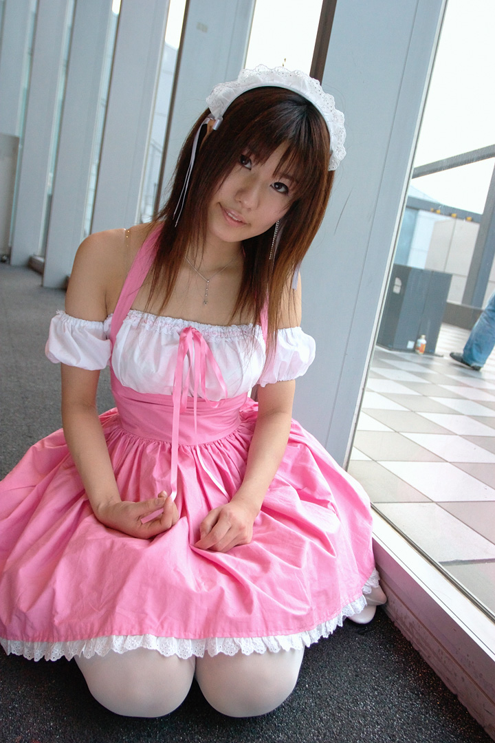 adachi mikki, photo (medium), 1girl, asian, bare shoulders, brown hair, dress, dutch angle, dyed hair, female focus, hair ribbon, hairband, indoors, jewelry, looking at viewer, necklace, ribbon, seiza, sitting, solo, thighhighs, waitress uniform, white thighhighs