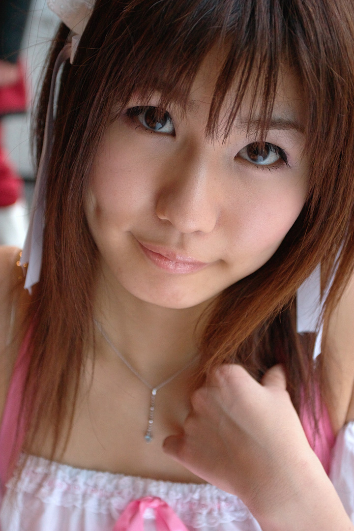 adachi mikki, photo (medium), 1girl, asian, bare shoulders, blurry, brown hair, depth of field, dress, dyed hair, female focus, hair ribbon, hairband, indoors, jewelry, looking at viewer, necklace, ribbon, solo, waitress uniform