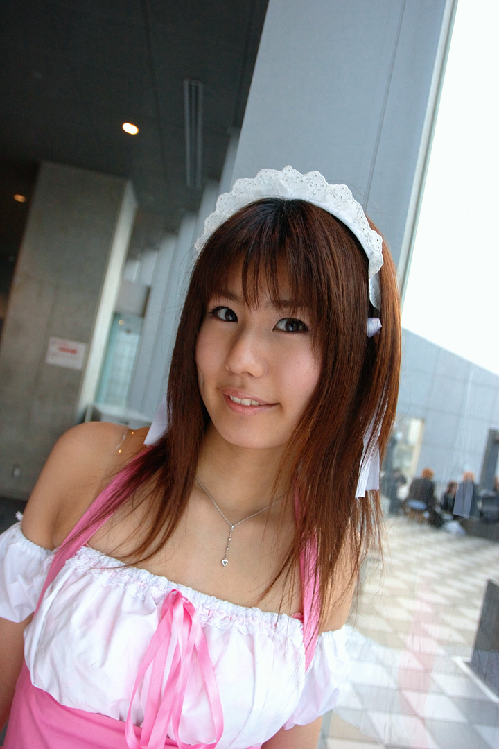 adachi mikki, photo (medium), 1girl, asian, bare shoulders, blurry, brown hair, depth of field, dress, dutch angle, dyed hair, female focus, hair ribbon, hairband, indoors, jewelry, light smile, looking at viewer, necklace, ribbon, solo, waitress uniform