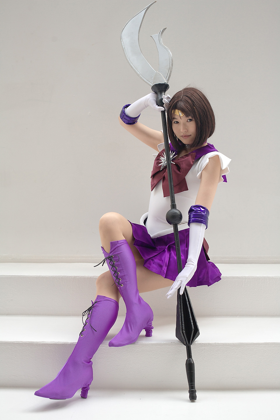 kumi, sailor saturn, tomoe hotaru, bishoujo senshi sailor moon, purple footwear, highres, photo (medium), boots, cosplay, elbow gloves, fang, glaive (polearm), gloves, pantyhose, polearm, purple skirt, shoes, silence glaive, skirt, weapon