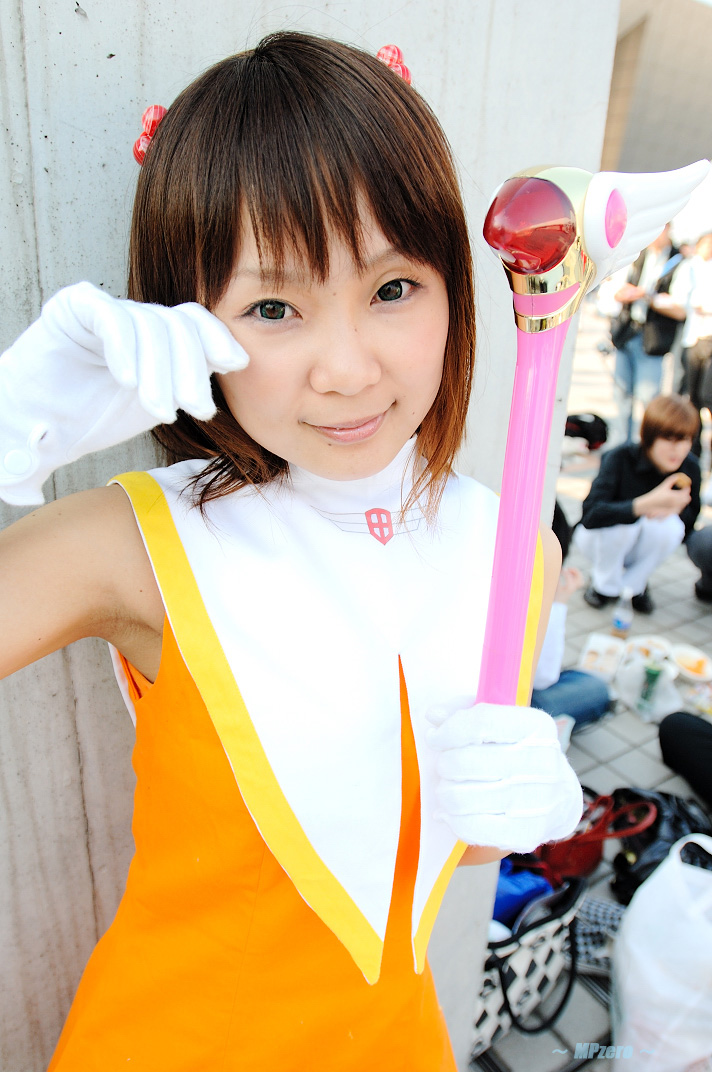 hiromichi, kinomoto sakura, cardcaptor sakura, photo (medium), 1girl, asian, brown hair, cheerleader, cosplay, fuuin no tsue, gloves, kinomoto sakura (cosplay), looking at viewer, outdoors, pom pom (cheerleading), smile, solo focus, wand