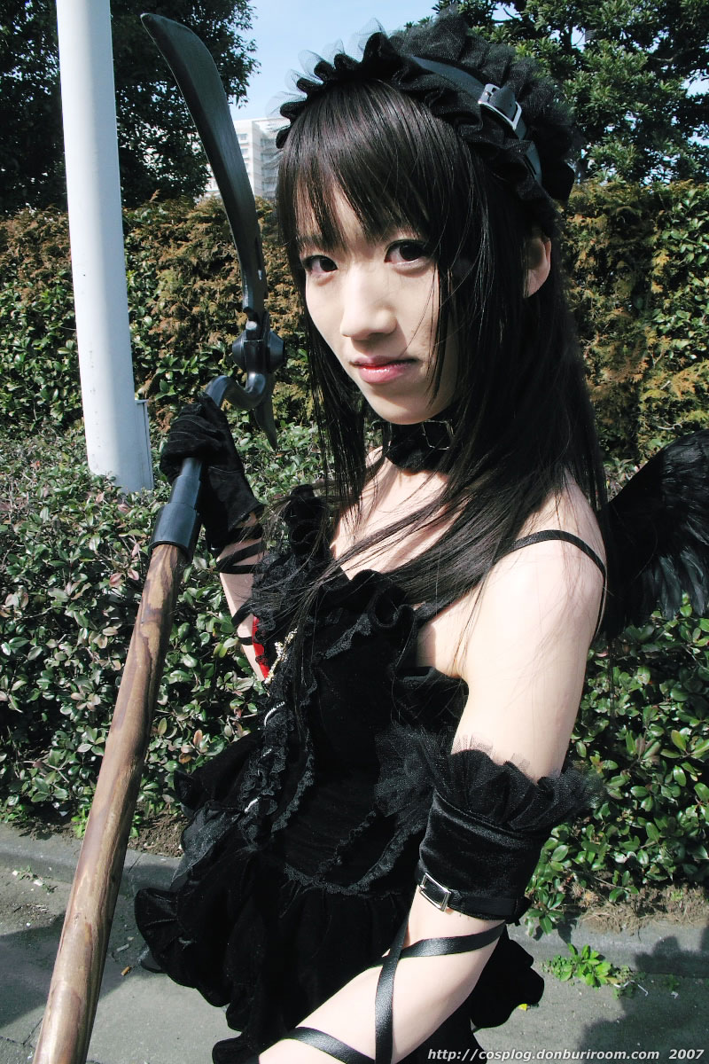 suzuyuki kaho, morte (vispo), vispo original, highres, photo (medium), tagme, 1girl, 2007, asian, bare shoulders, black dress, black gloves, cosplay, cross, dress, female focus, frills, gloves, gothic lolita, hairband, hedge, japanese (nationality), lolita fashion, lolita hairband, looking at viewer, outdoors, scythe, short dress, solo, standing, tree, watermark, weapon, web address, wings