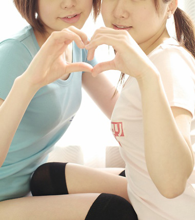 miasa, namada, black legwear, lowres, photo (medium), translated, 2girls, asian, black hair, brown hair, clothes writing, heart, heart hands, heart hands duo, indoors, long hair, multiple girls, shirt, short hair, t-shirt, thighhighs, twintails