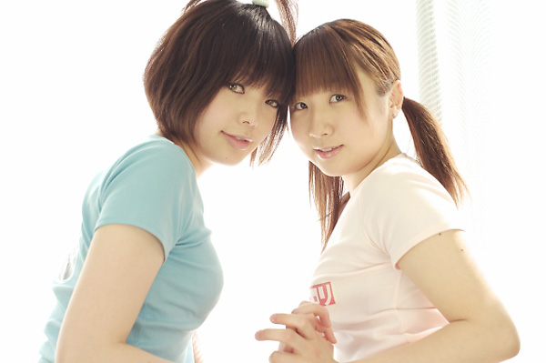 miasa, namada, photo (medium), translated, 2girls, asian, black hair, brown eyes, brown hair, clothes writing, color contacts, holding hands, indoors, long hair, looking at viewer, multiple girls, shirt, short hair, t-shirt, twintails