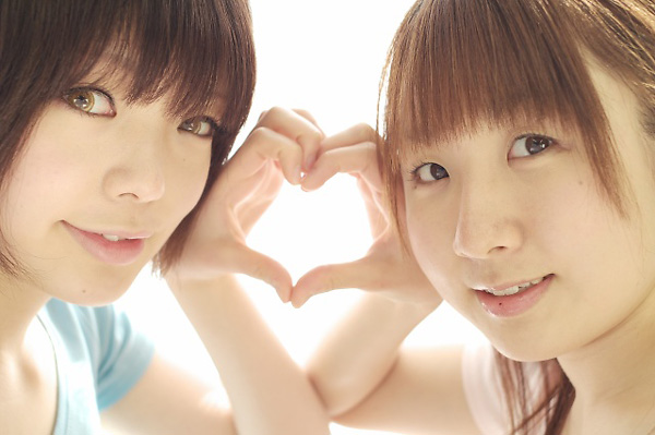 miasa, namada, photo (medium), 2girls, asian, black hair, brown eyes, brown hair, color contacts, heart, heart hands, heart hands duo, long hair, looking at viewer, multiple girls, shirt, short hair, simple background, t-shirt, twintails, white background