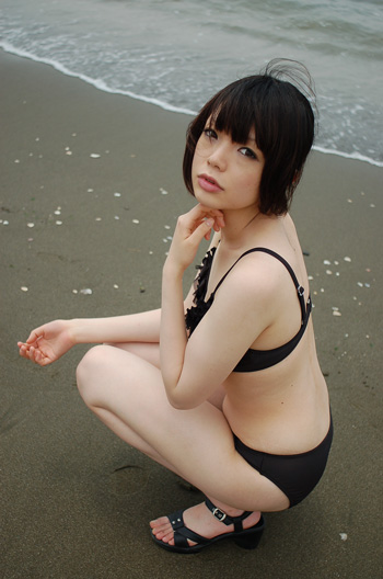 namada, photo (medium), tagme, 1girl, asian, beach, bikini, black bikini, black hair, black sandals, breasts, female focus, full body, looking at viewer, outdoors, sandals, short hair, small breasts, solo, squatting, swimsuit