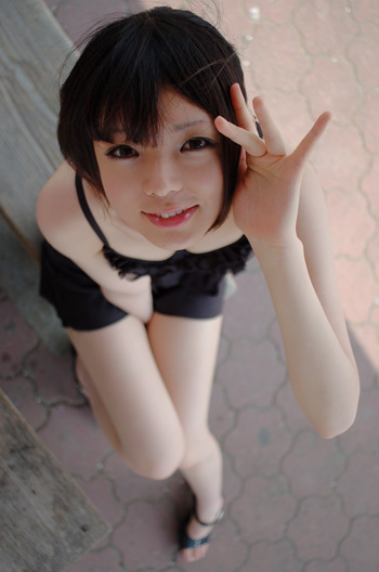 namada, photo (medium), tagme, 1girl, asian, bikini, black bikini, black sandals, blurry, breasts, depth of field, dutch angle, female focus, looking at viewer, on floor, sandals, sarong, sitting, small breasts, smile, solo, swimsuit