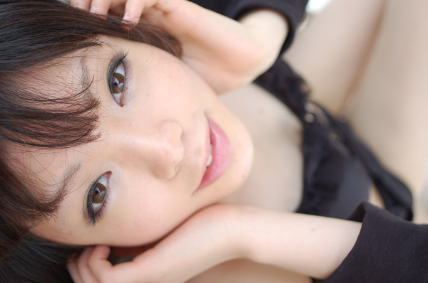 namada, photo (medium), tagme, 1girl, asian, bikini, black bikini, blurry, breasts, brown eyes, depth of field, dutch angle, female focus, looking at viewer, sarong, small breasts, smile, solo, swimsuit
