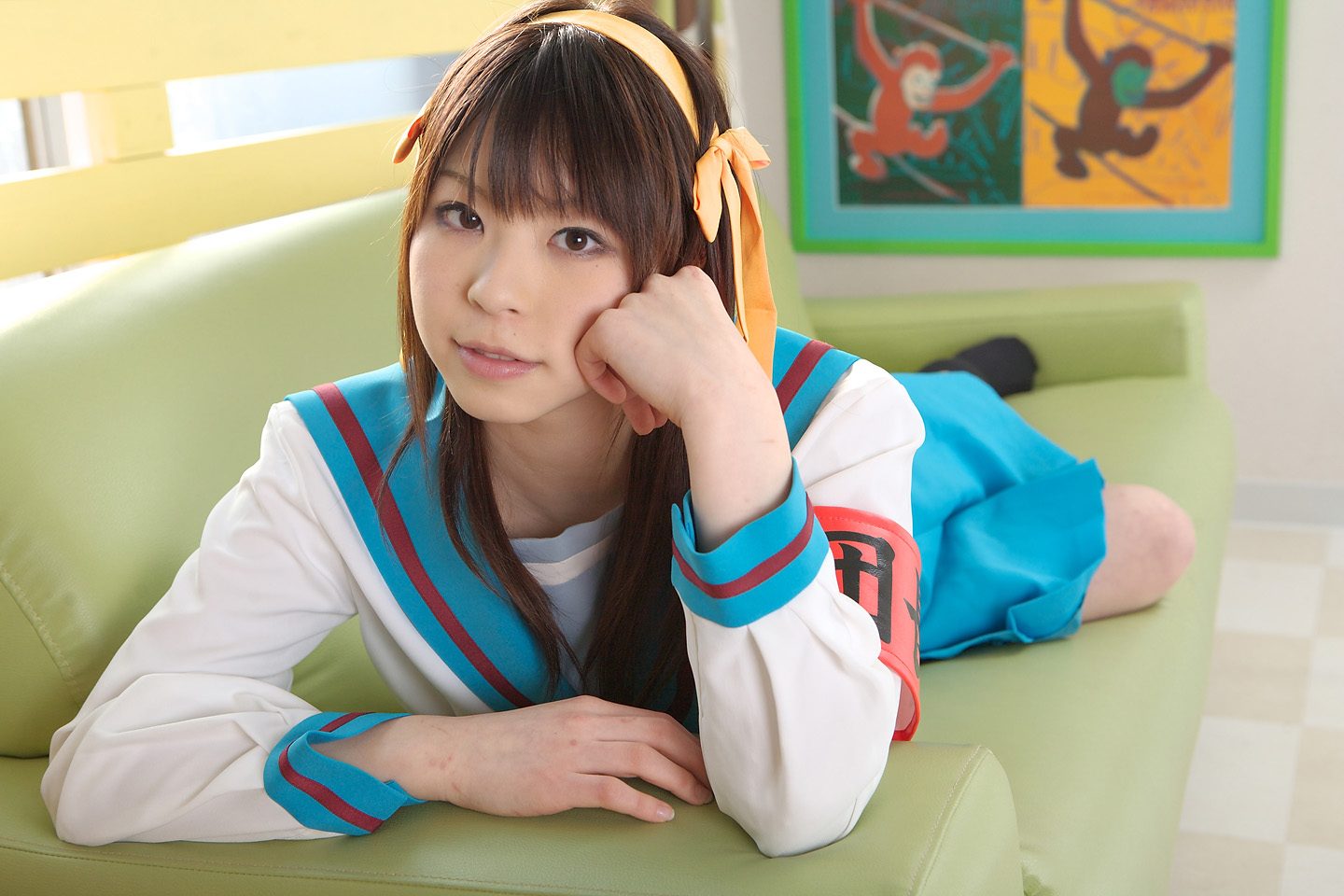 katou mari, suzumiya haruhi, suzumiya haruhi no yuuutsu, photo (medium), armband, cosplay, lying, on stomach, sailor, school uniform, serafuku