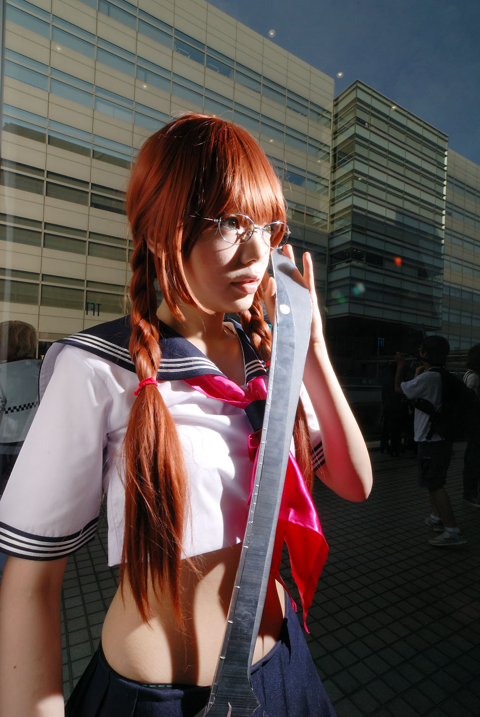namada, arisugawa shii, the art of yamashita shunya, highres, photo (medium), 1girl, aqua eyes, arisugawa shii (cosplay), asian, blue eyes, blurry, braid, brown hair, color contacts, cosplay, crop top, depth of field, female focus, glasses, green eyes, indoors, lensless glasses, long hair, looking at viewer, midriff, pleated skirt, sailor, school uniform, serafuku, short sleeves, skirt, solo, standing, sword, twin braids, weapon