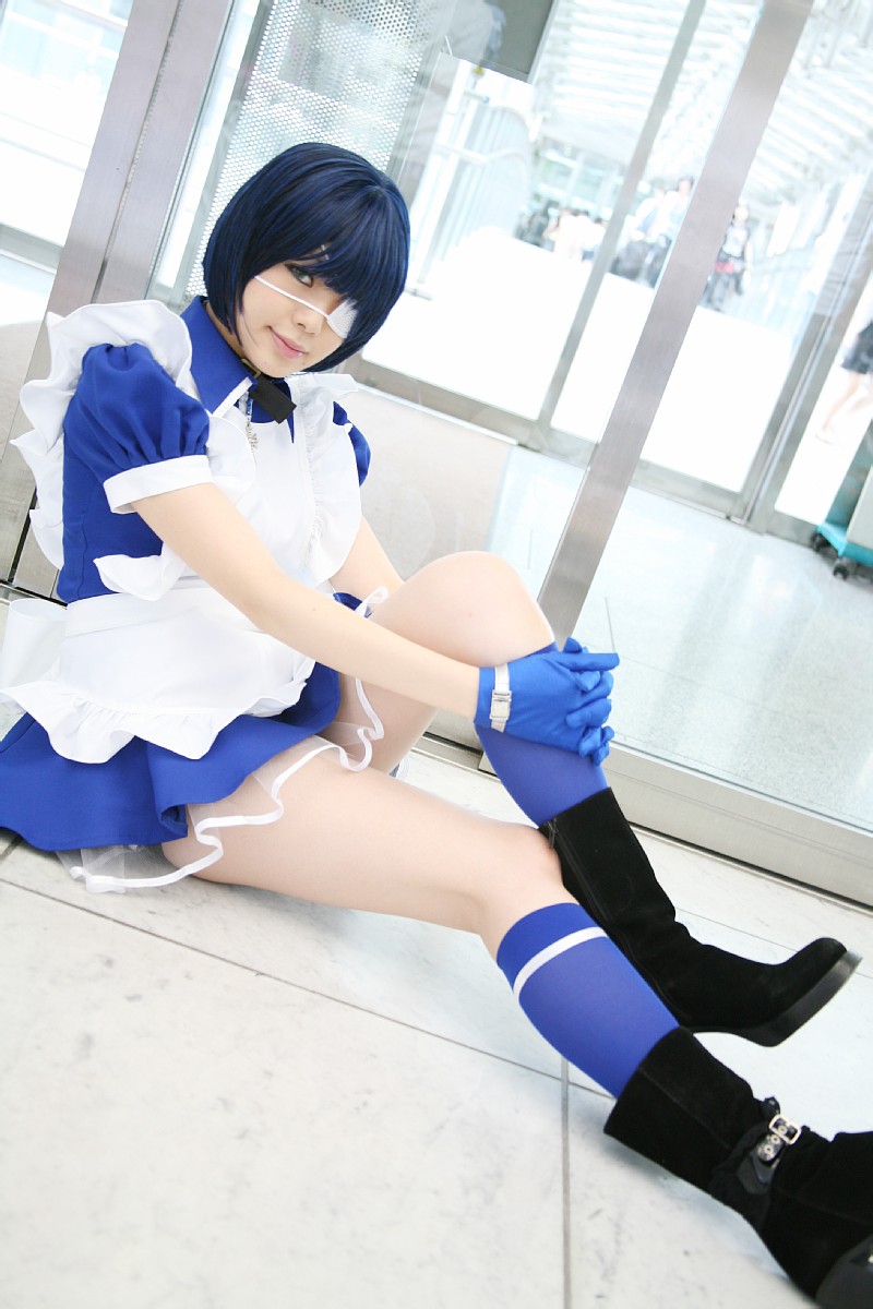 namada, ryomou shimei, ikkitousen, highres, photo (medium), 1girl, apron, asian, black boots, blue eyes, blue gloves, blue hair, blue socks, boots, collar, color contacts, cosplay, cross, cuffs, dutch angle, eyepatch, female focus, gloves, handcuffs, high heels, hugging own legs, indoors, kneehighs, looking at viewer, maid, maid apron, on floor, puffy short sleeves, puffy sleeves, ryomou shimei (cosplay), short sleeves, sitting, socks, solo