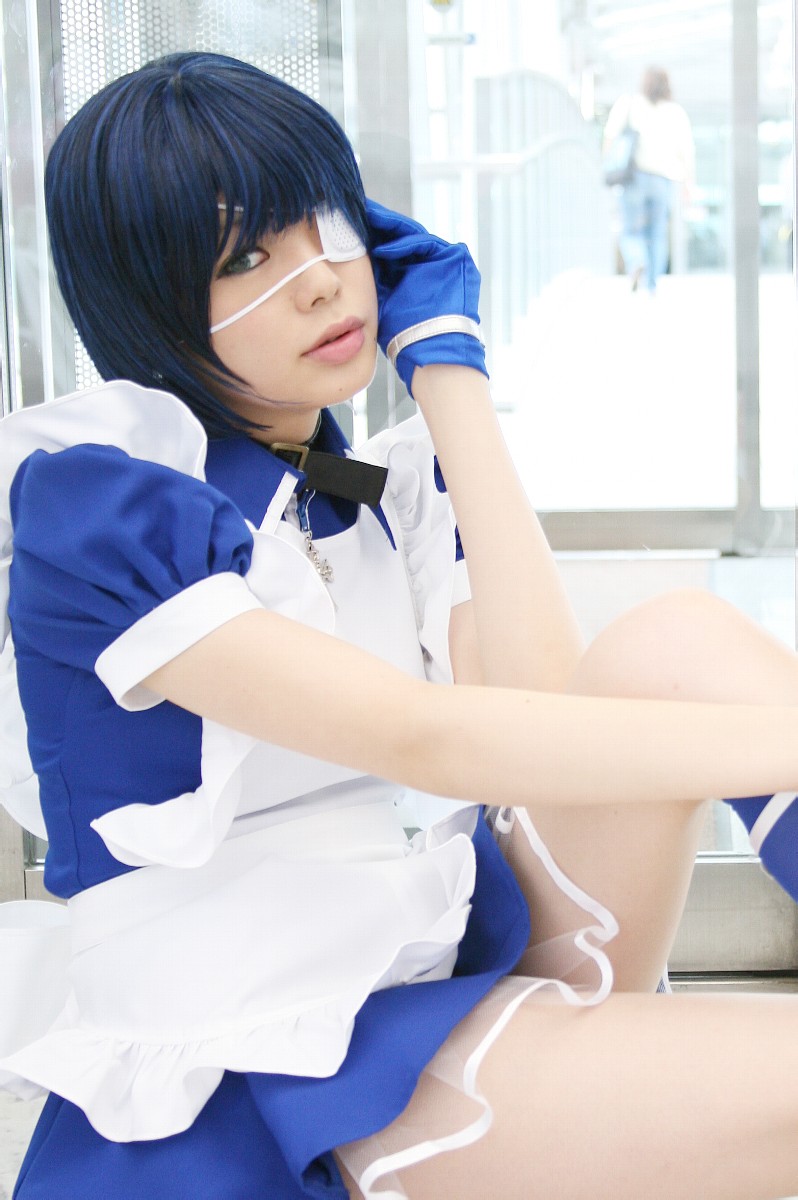 namada, ryomou shimei, ikkitousen, highres, photo (medium), 1girl, apron, asian, blue eyes, blue gloves, blue hair, blue socks, collar, color contacts, cosplay, cross, cuffs, eyepatch, female focus, gloves, handcuffs, indoors, kneehighs, looking at viewer, maid, maid apron, on floor, puffy short sleeves, puffy sleeves, ryomou shimei (cosplay), short sleeves, sitting, socks, solo