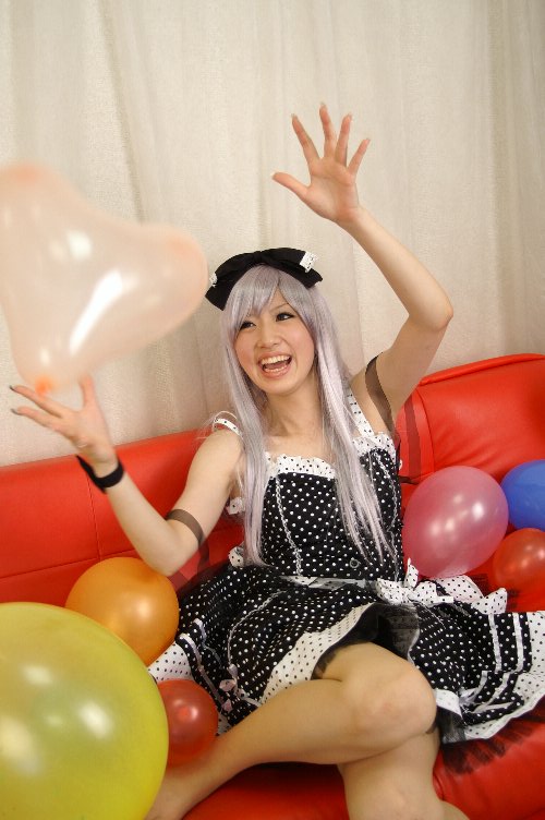 saya (cosplayer), silver hair, photo (medium), 1girl, balloon, bow, cosplay, couch, dress, hair bow, red upholstery, ribbon