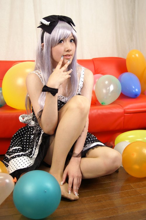 saya (cosplayer), silver hair, photo (medium), 1girl, asian, balloon, bow, cosplay, couch, dress, female focus, hair bow, nail polish, polka dot, polka dot dress, red upholstery, ribbon, sitting