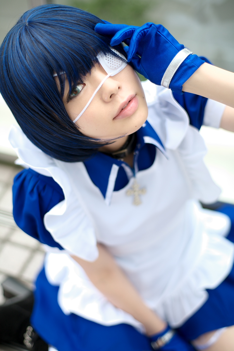 namada, ryomou shimei, ikkitousen, highres, photo (medium), 1girl, apron, asian, blue eyes, blue gloves, blue hair, blurry, boots, collar, color contacts, cosplay, cross, cuffs, depth of field, eyepatch, female focus, gloves, handcuffs, kneehighs, looking at viewer, maid, maid apron, outdoors, puffy short sleeves, puffy sleeves, ryomou shimei (cosplay), short sleeves, socks, solo